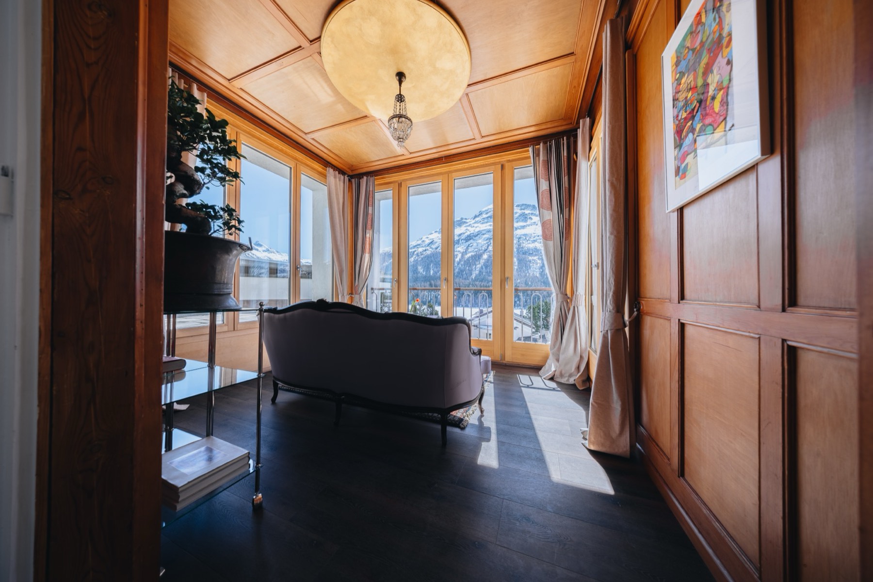 Lake Suite with Terrace at Villa Beaulieu, a wood-panelled sitting room overlooking the lake